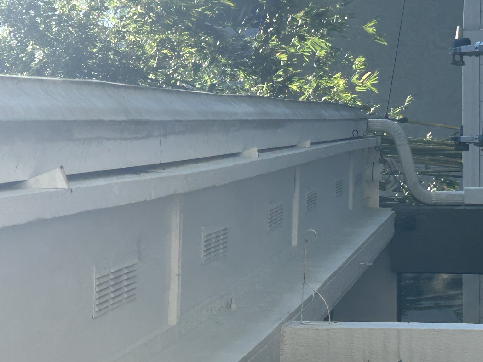 Gutter and downspout run tied into the soffit on a two-story home